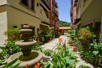 Beautifully landscaped courtyard with fountain and lush tropical plants